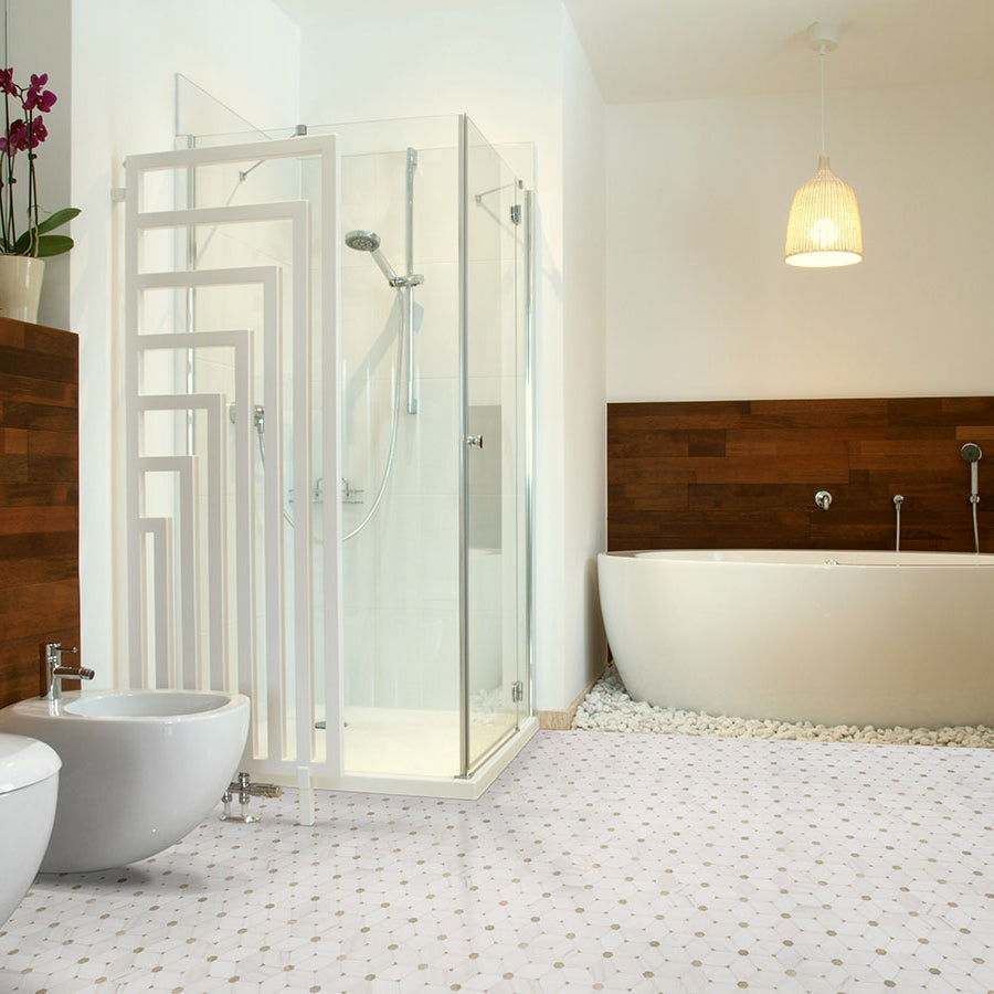 Natural stone mosaic tile installed on shower floor with soft white and gray tones