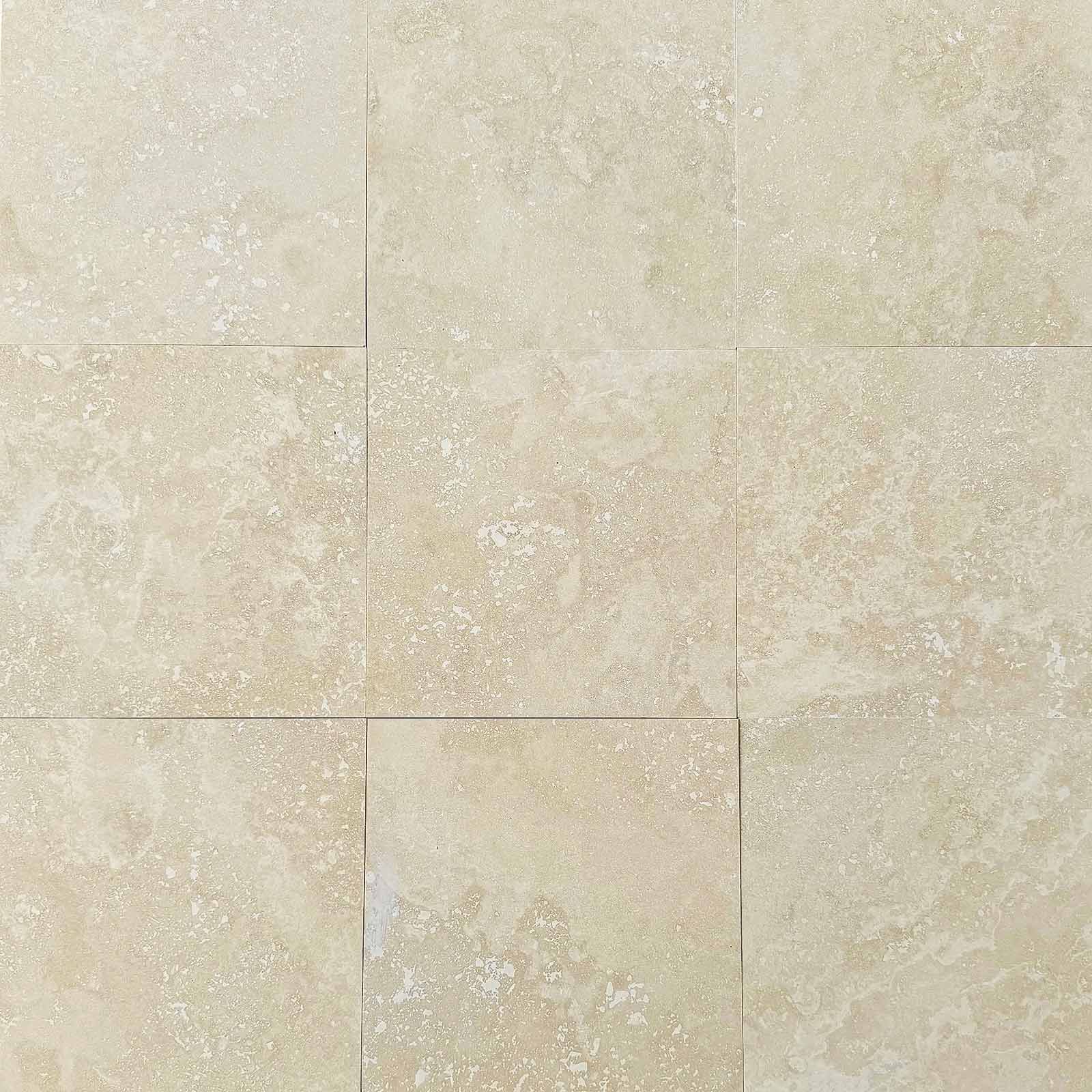 Assorted honed natural stone tiles in marble and travertine, displayed with smooth matte finish and soft neutral tones