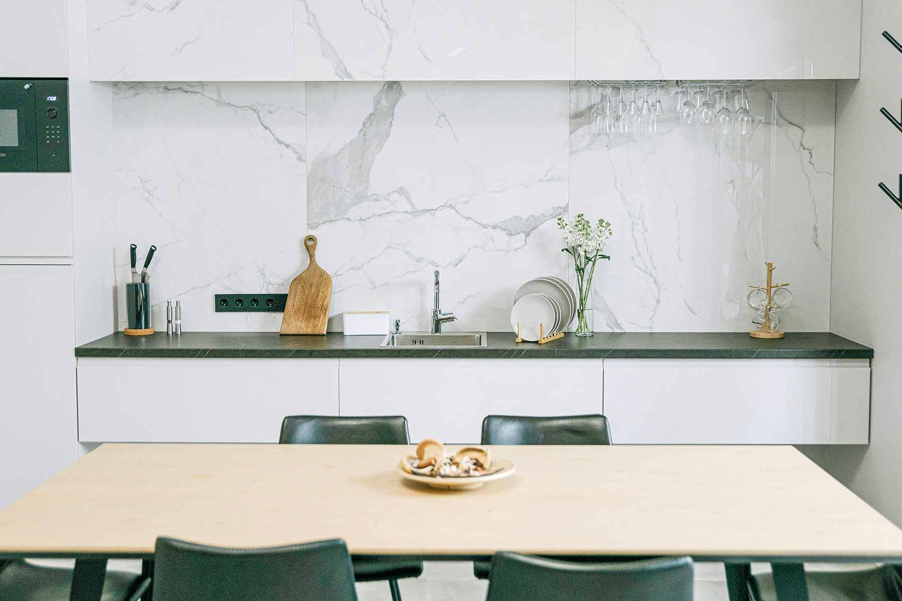 Natural stone backsplash tiles in subway and mosaic patterns, featuring marble in kitchen