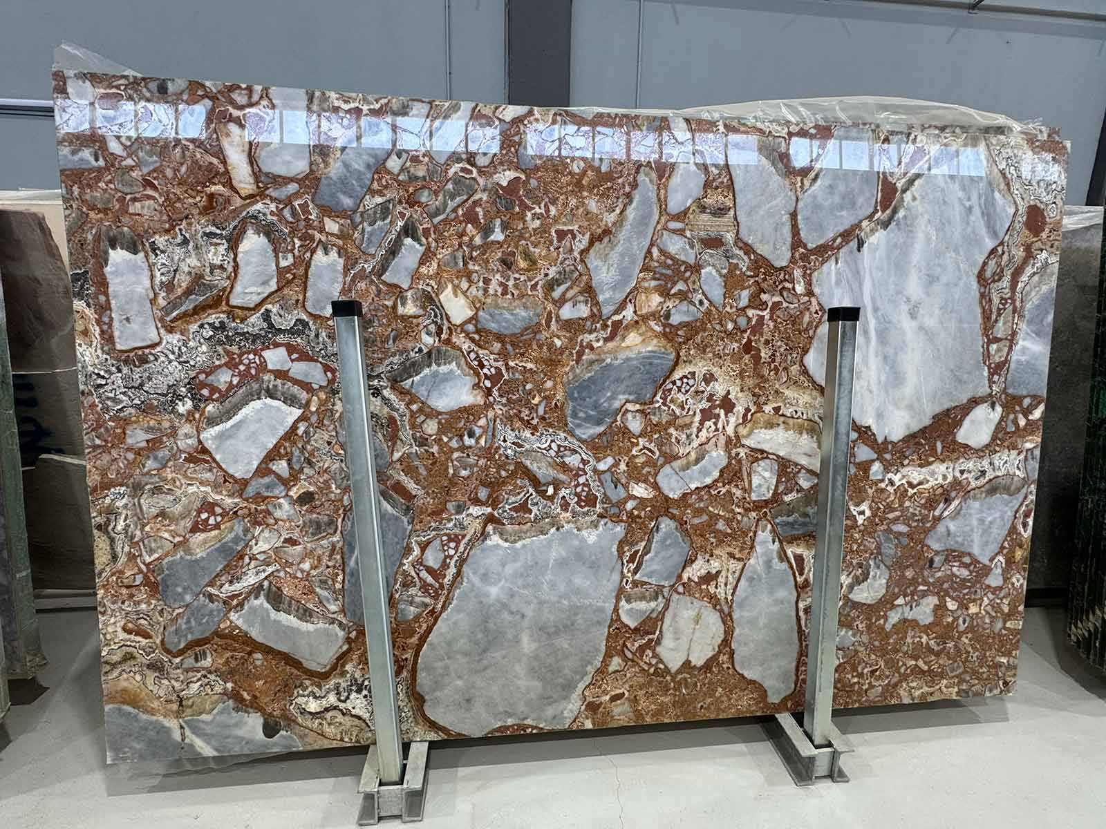 Flat view of Red Fusion Marble Slab in polished finish showing red, gray, and ivory brecciated pattern