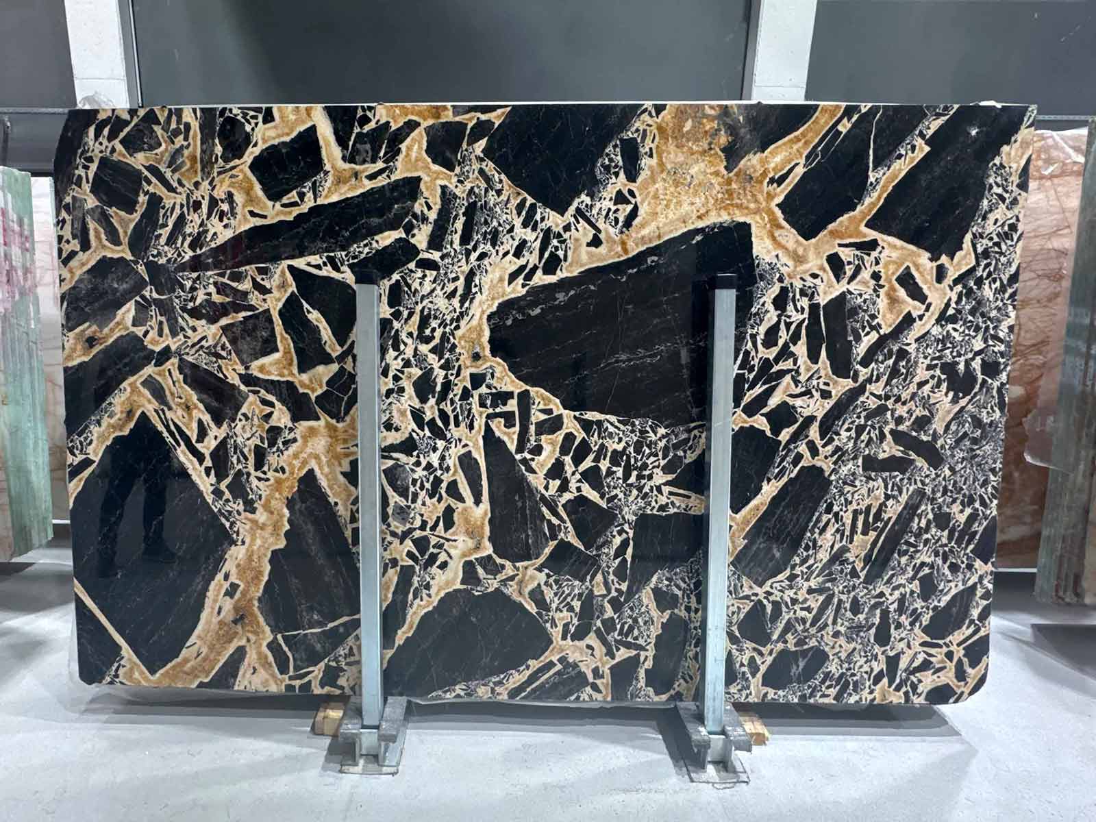 Flat view of Serengeti Leopard Marble Slab in polished finish showing black and gold brecciated pattern