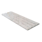 Edge of Arabescato Venato marble showing linear fluted design and soft veining