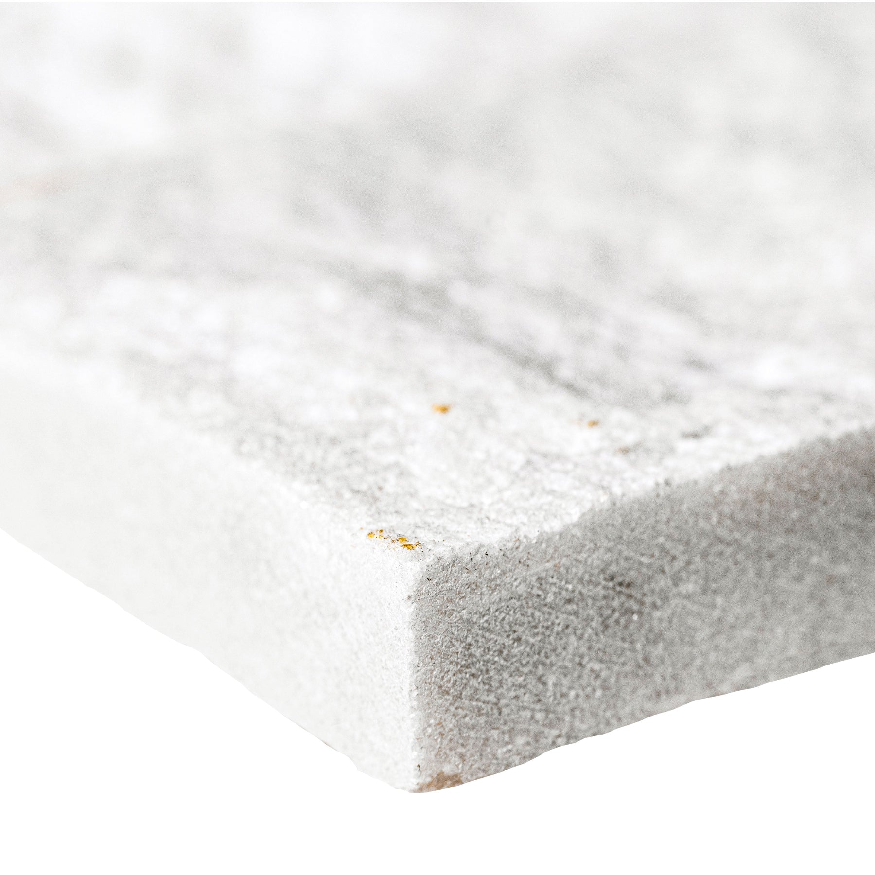 Close-up of Arctic White Quartzite showing split-face texture and dimensional surface