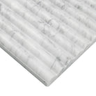 Edge of Carrara White marble showing ribbed texture and elegant gray veining