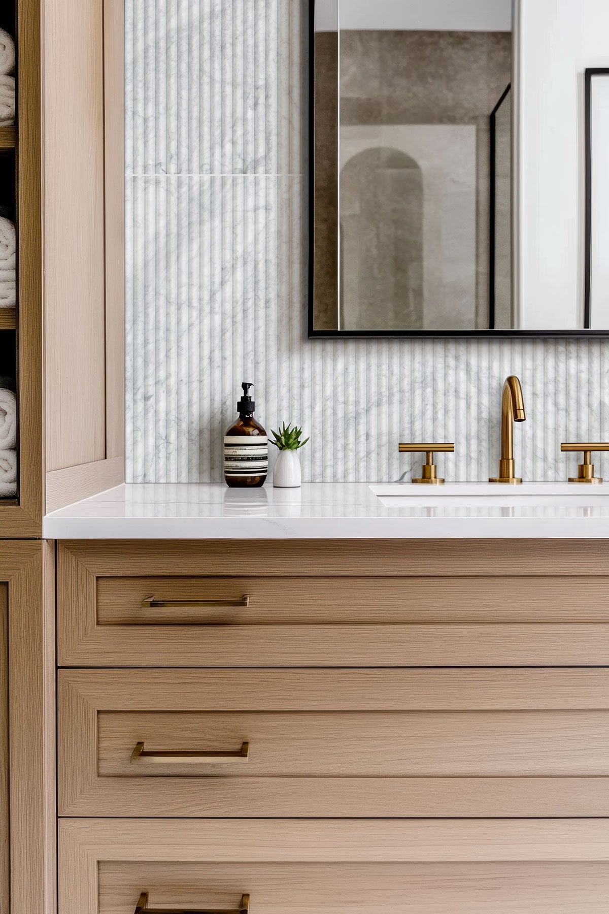 Carrara White Milano Ribbo Marble Tiles installed on bathroom wall with honed finish