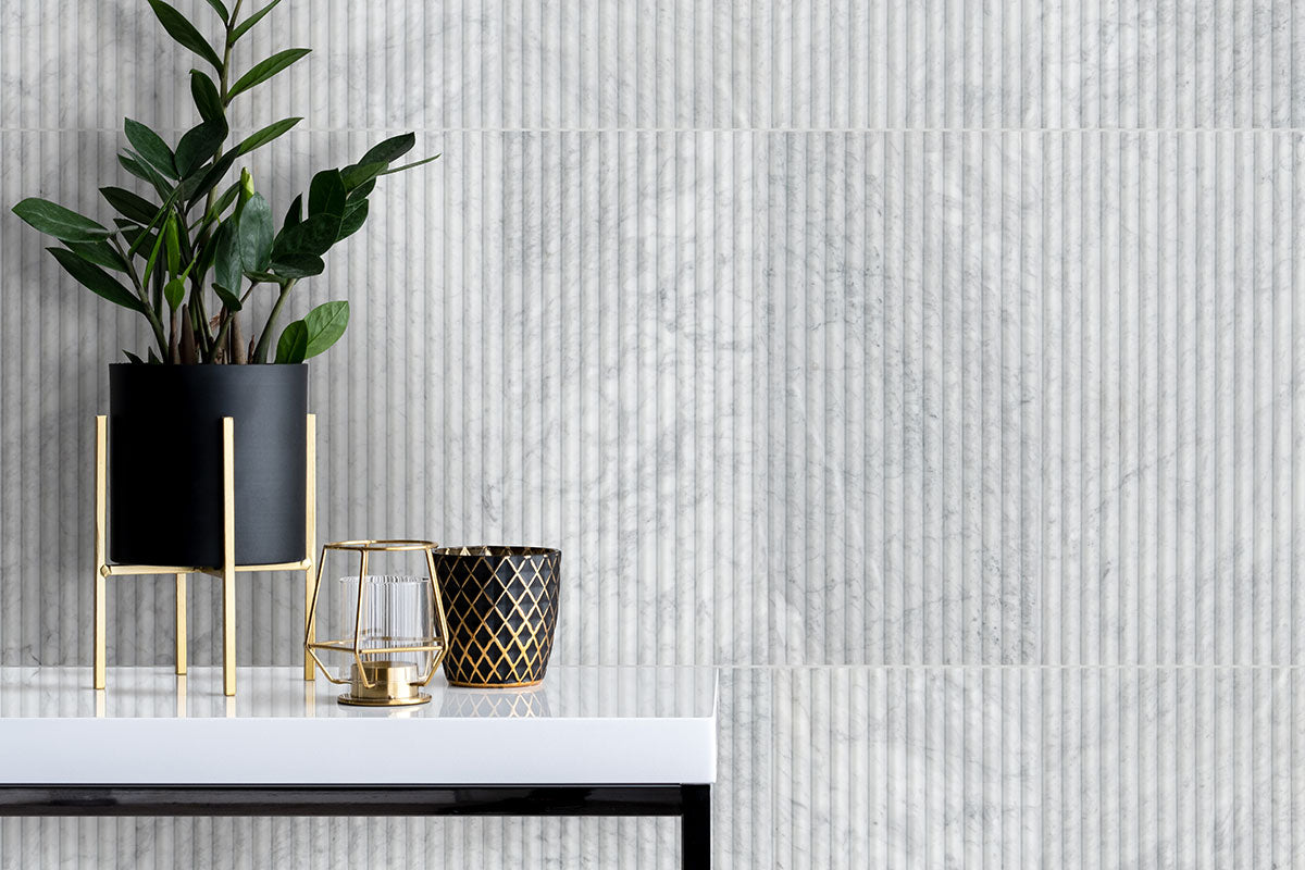 Carrara White Milano Ribbo Marble Tiles installed on accent wall with honed finish