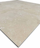 Close-up of Ivory Light Travertine 12x12 Honed Filled Tile showing matte finish and natural stone details