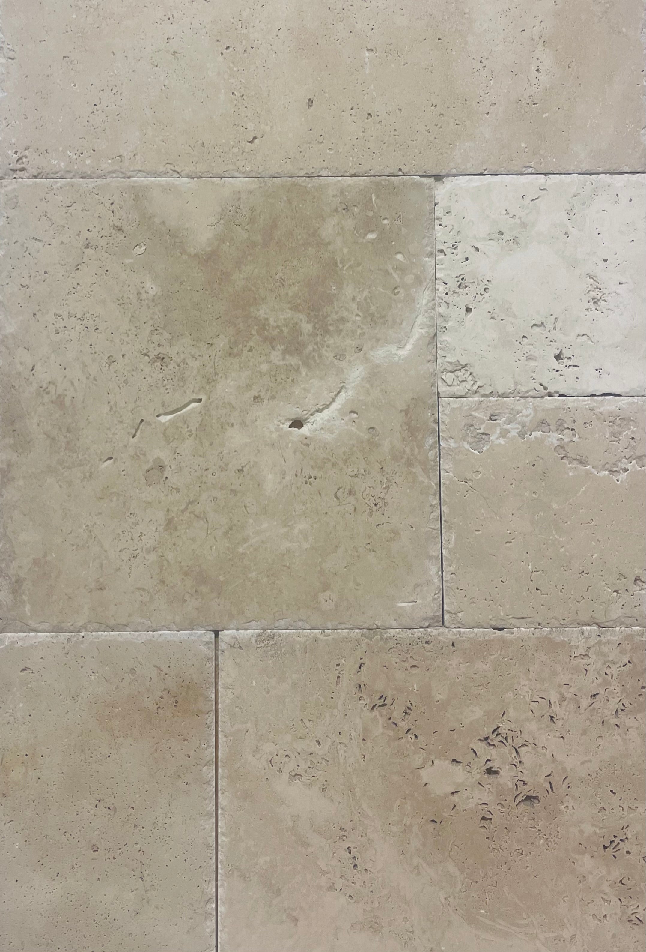 Versailles pattern Coliseum Travertine with brushed and chiseled finish in neutral gray and cream tones