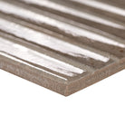 Close-up of Gems Grigio showing soft green tones, copper accents, and fluted texture