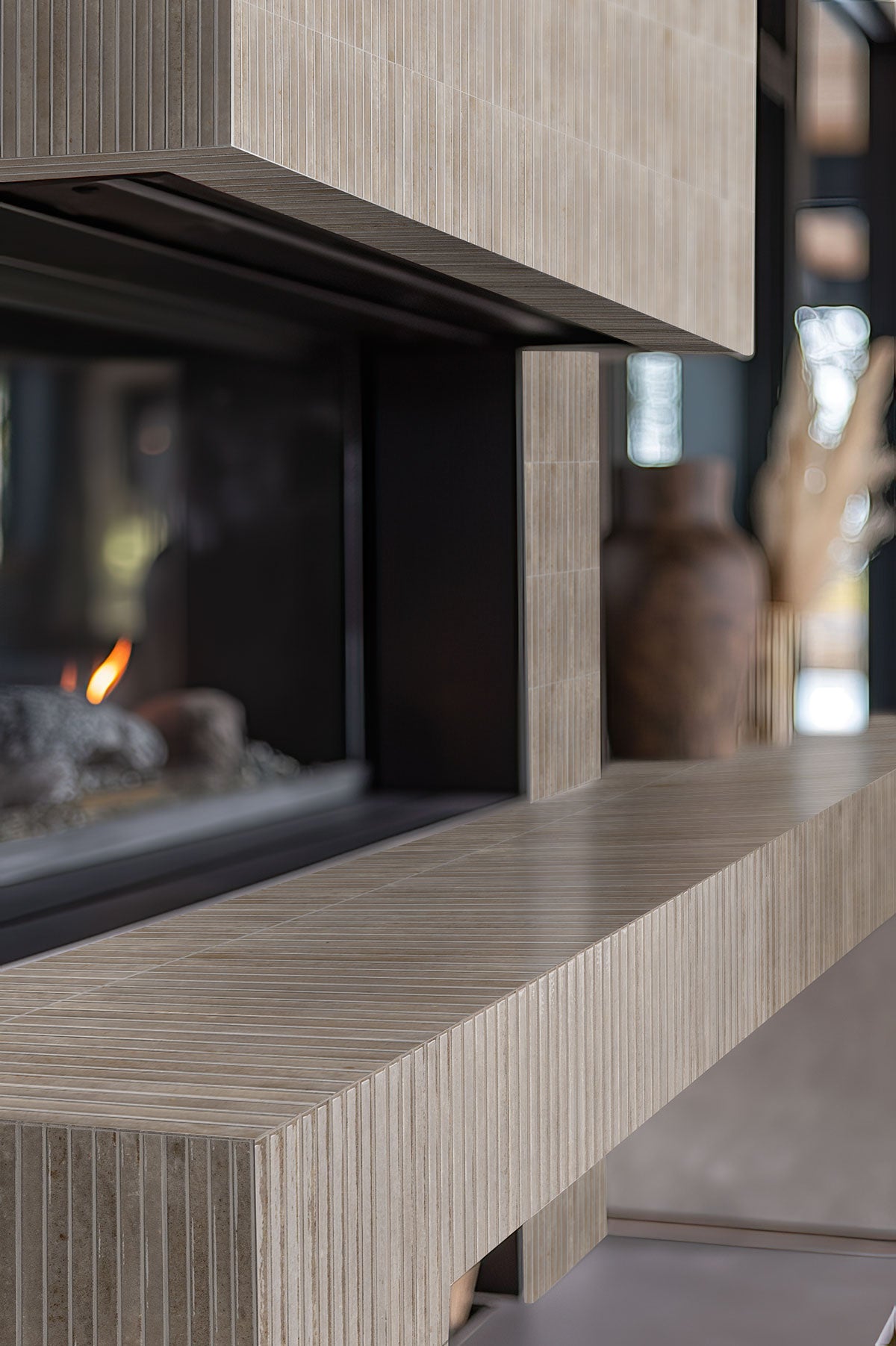 Gems Grigio Fluted Tiles installed on a fireplace wall with seamless grout finish