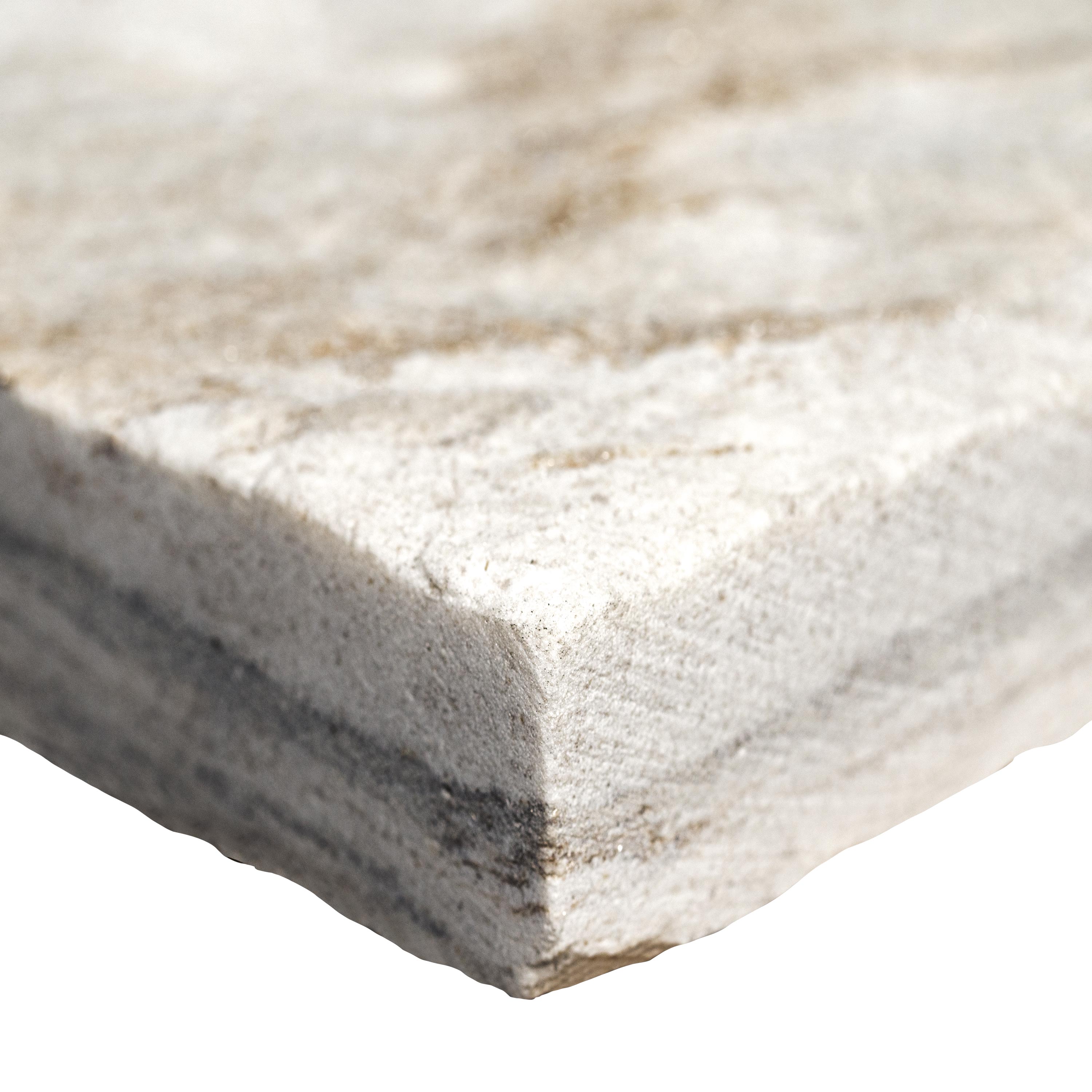 Close-up of Royal White Quartzite showing split-face texture and soft beige veining