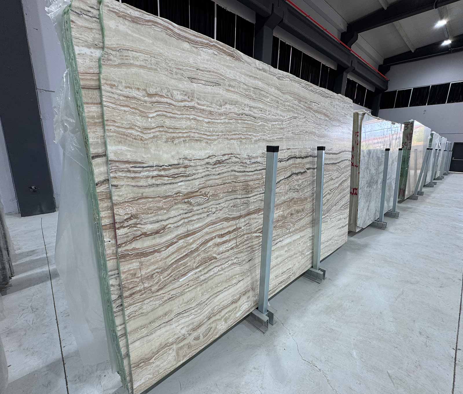 Sand Drift Marble Slab in honed finish showing ivory and sand-toned horizontal veining