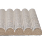 Close-up of Sinfonia Piano Ceniza showing 3D fluted design and soft gray tones