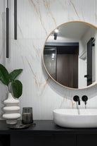 Urbanslat Marmi Gold Wall Panels installed on modern bathroom with seamless vertical layout