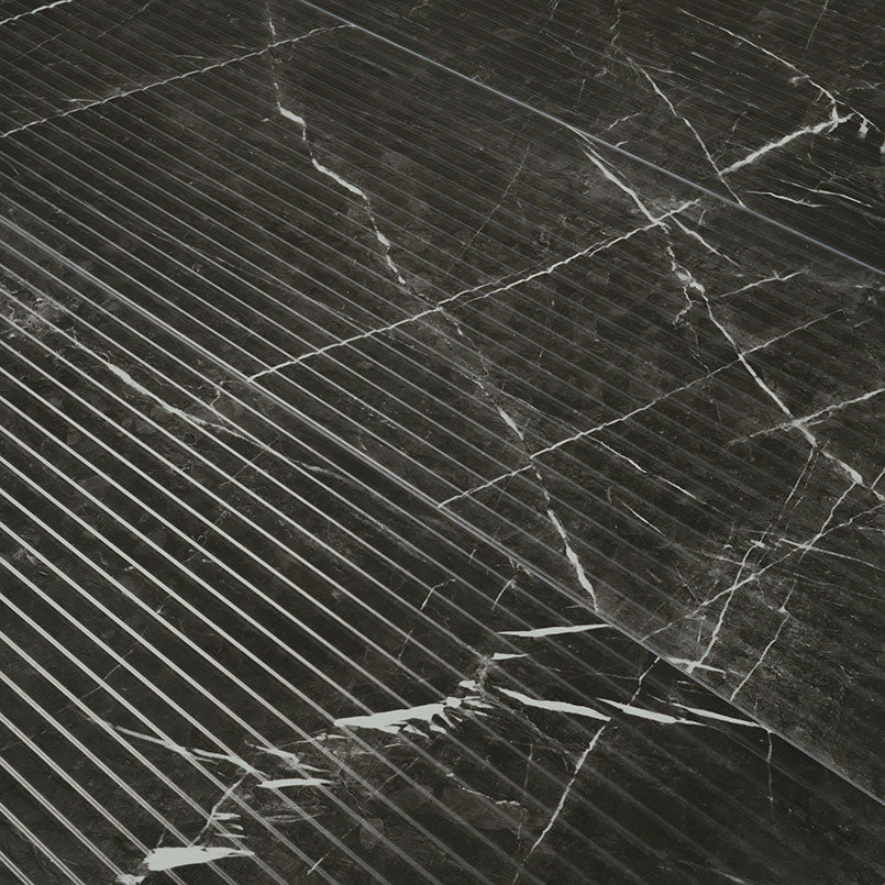 Close-up of Urbanslat Marmi Noir showing fluted 3D texture and black surface with white veining