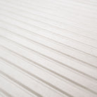 Close-up of Urbanslat White Wood Look showing 3D fluted texture and clean white tones