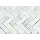 Close-up of 1x3 herringbone mosaic showing Carrara white marble veining