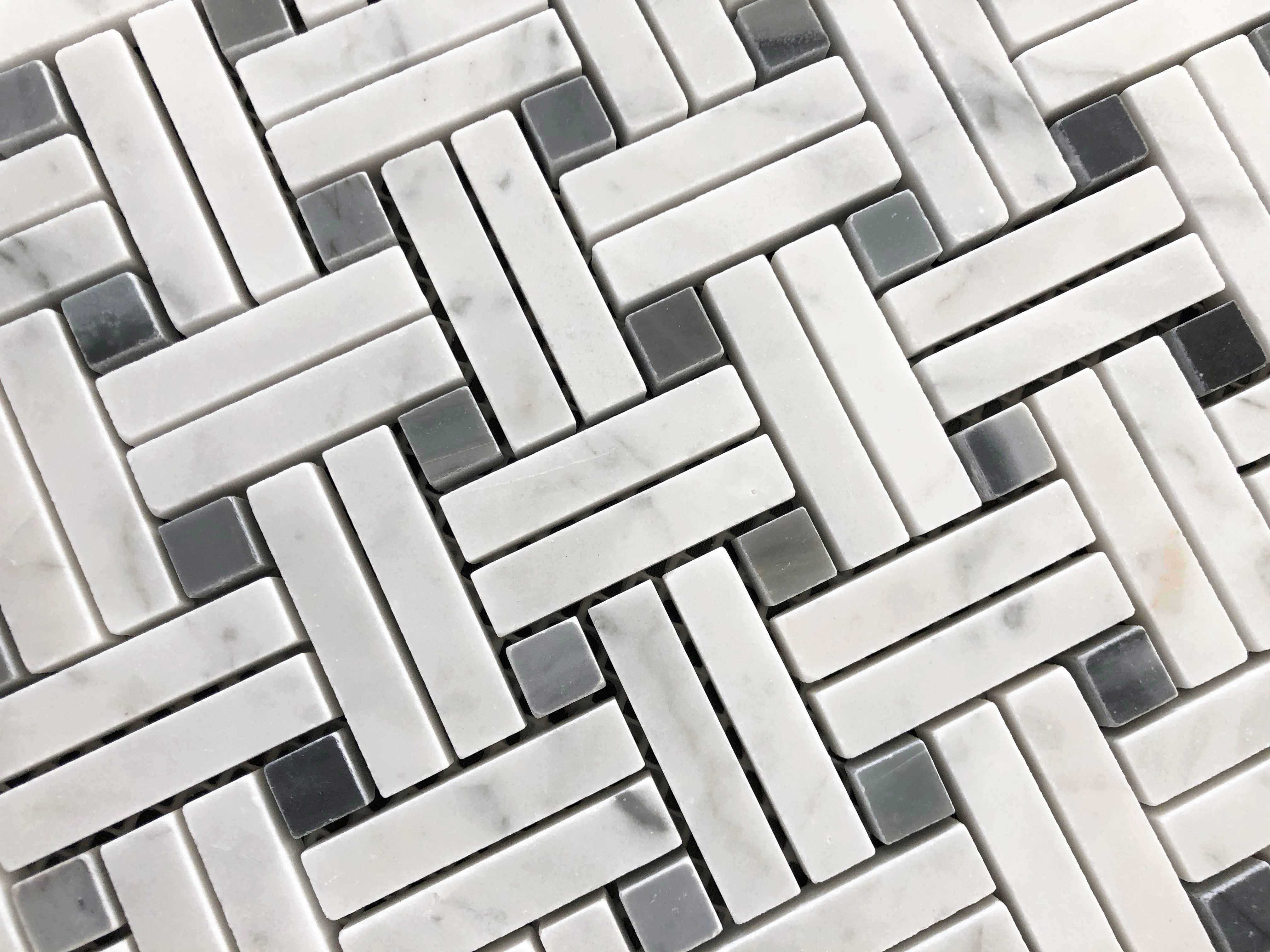 Close-up of Carrara Stanza Mosaic with stacked marble rectangles and blue accents