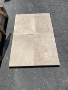 Close-up of Dark Walnut Travertine showing textured surface and deep earth tones