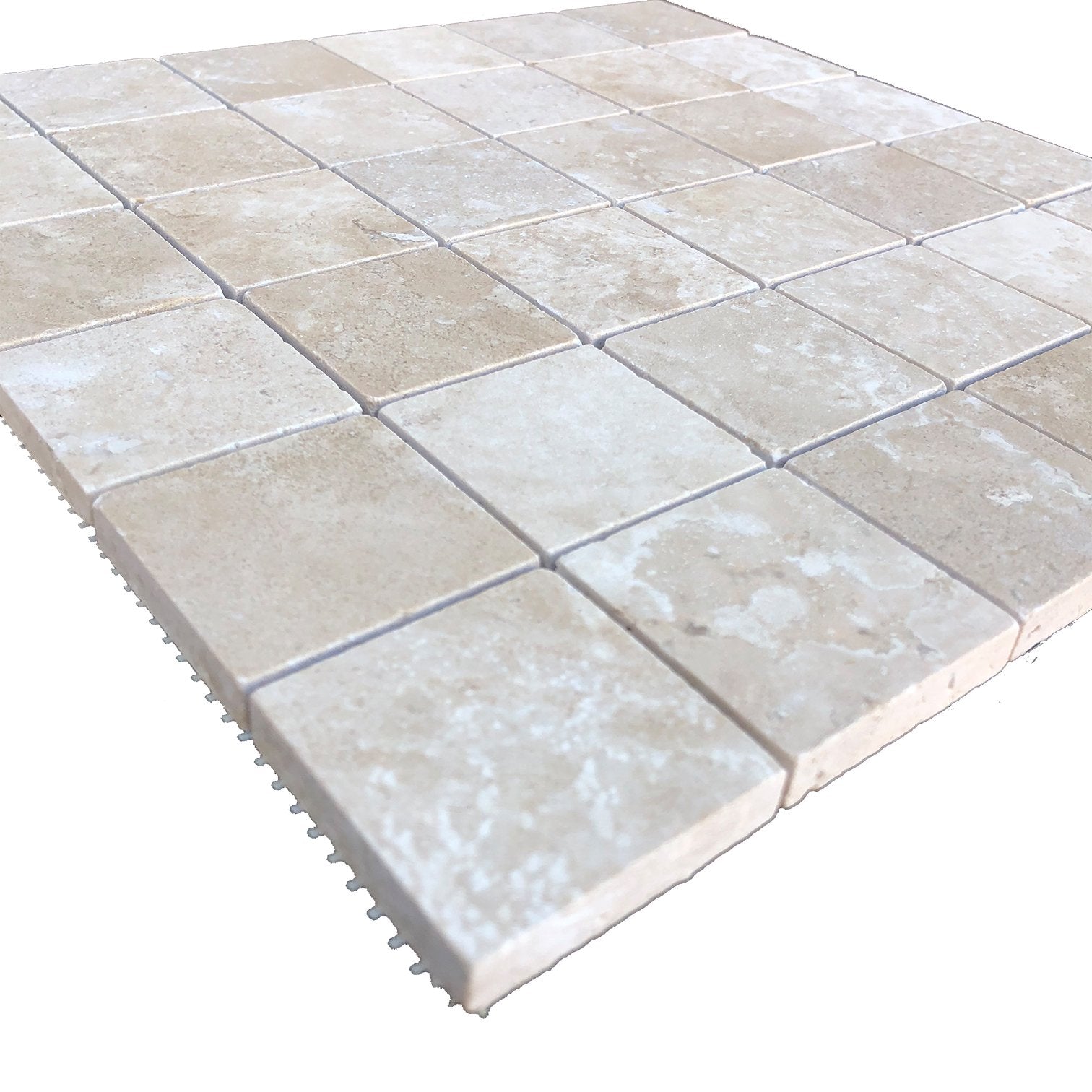 Close-up of 2x2 travertine tile showing honed texture and warm tones