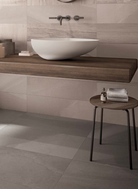 Flat lay of Fluido Sabbia 16x32 porcelain tile in natural sandy beige tones.