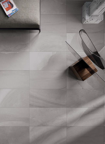 Flat lay view of Fluido Titano 16x32 porcelain tile in sandstone beige tones.