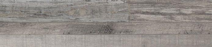 Close-up of Mezcla plank surface showcasing charcoal wood knots and textured matte finish