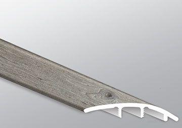 Close-up of Mezcla plank surface showcasing charcoal wood knots and textured matte finish