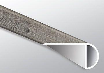 Close-up of Mezcla plank surface showcasing charcoal wood knots and textured matte finish