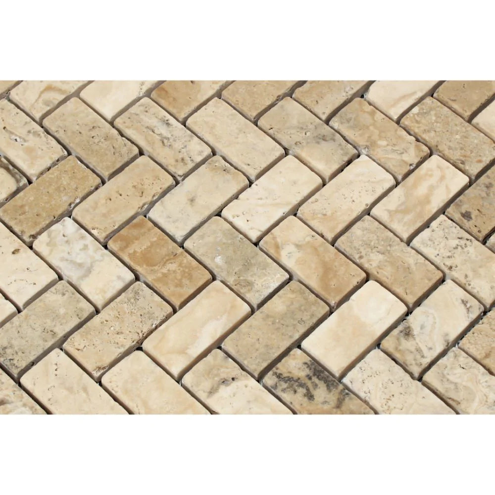 Tumbled travertine herringbone mosaic with neutral tones