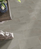 Close-up of Sande Cream 24x48 porcelain tile showing subtle linear pattern and polished texture
