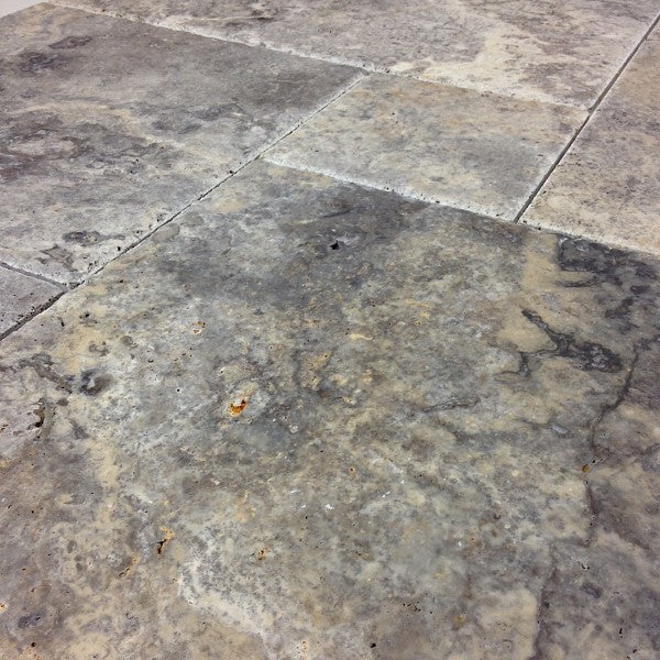 Close-up of Silver Travertine showing brushed texture and chiseled edge detail