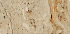 Close-up of 3x6 Valencia Travertine tile with tumbled finish and textured surface
