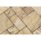 Close-up of tumbled Valencia Travertine showing warm rust, cream, and red tones in Mini Versailles pattern