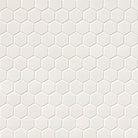 Close-up of glossy 2-inch porcelain hex tiles with soft cream tone and clean grout spacing