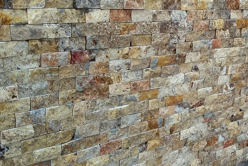 Scabos Travertine tiles in warm gold, rust, and walnut tones arranged in a natural stone layout