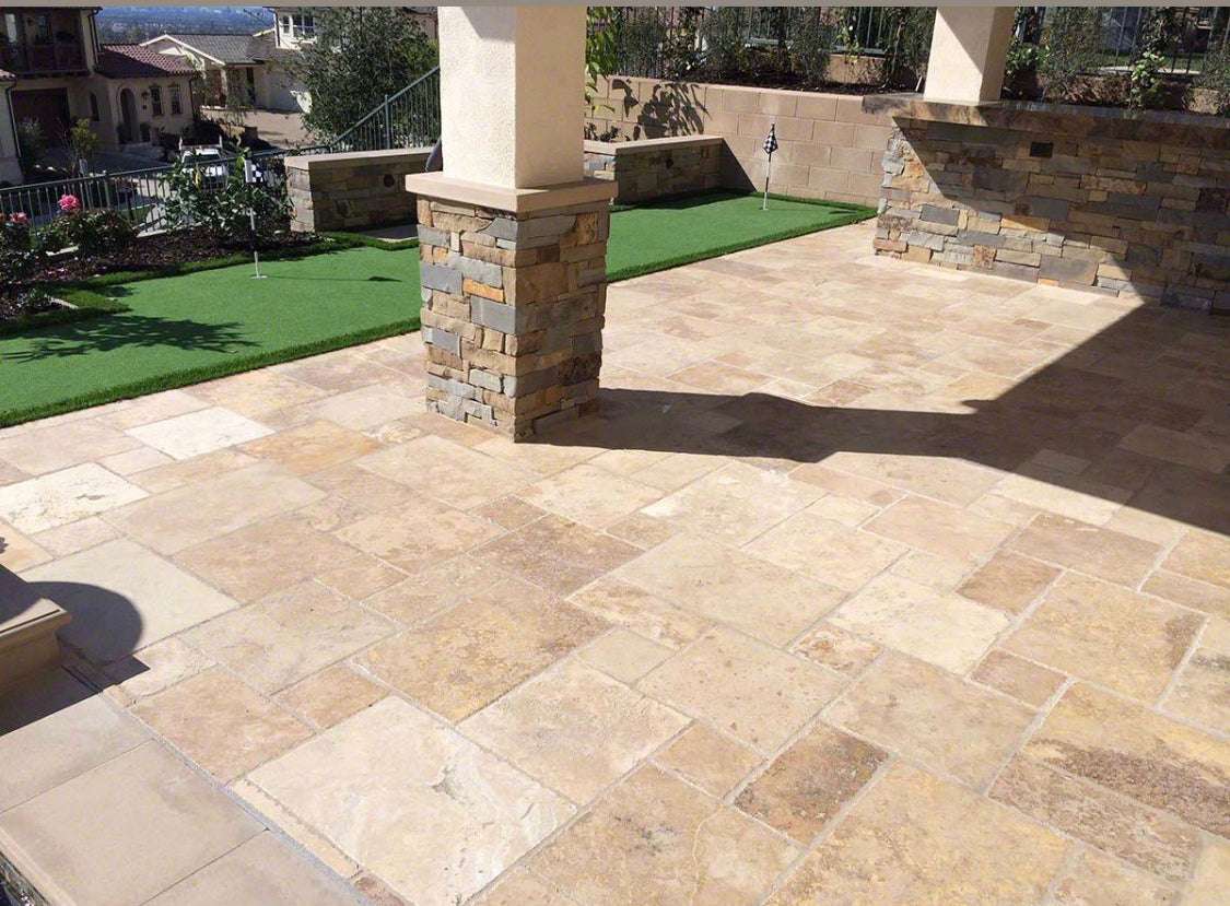 Installed Tuscany Mix Travertine tile showing warm gold, rust, and brown tones in natural finish