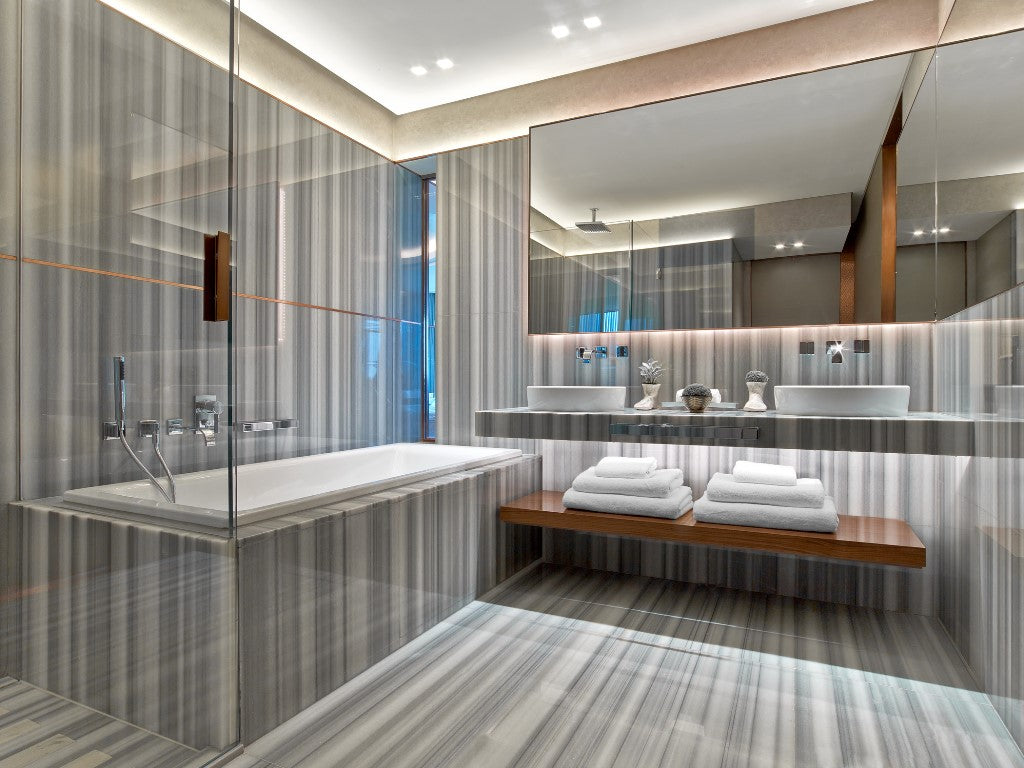 Installed view of mink marble tiles showing subtle gray veining in a modern bathroom wall