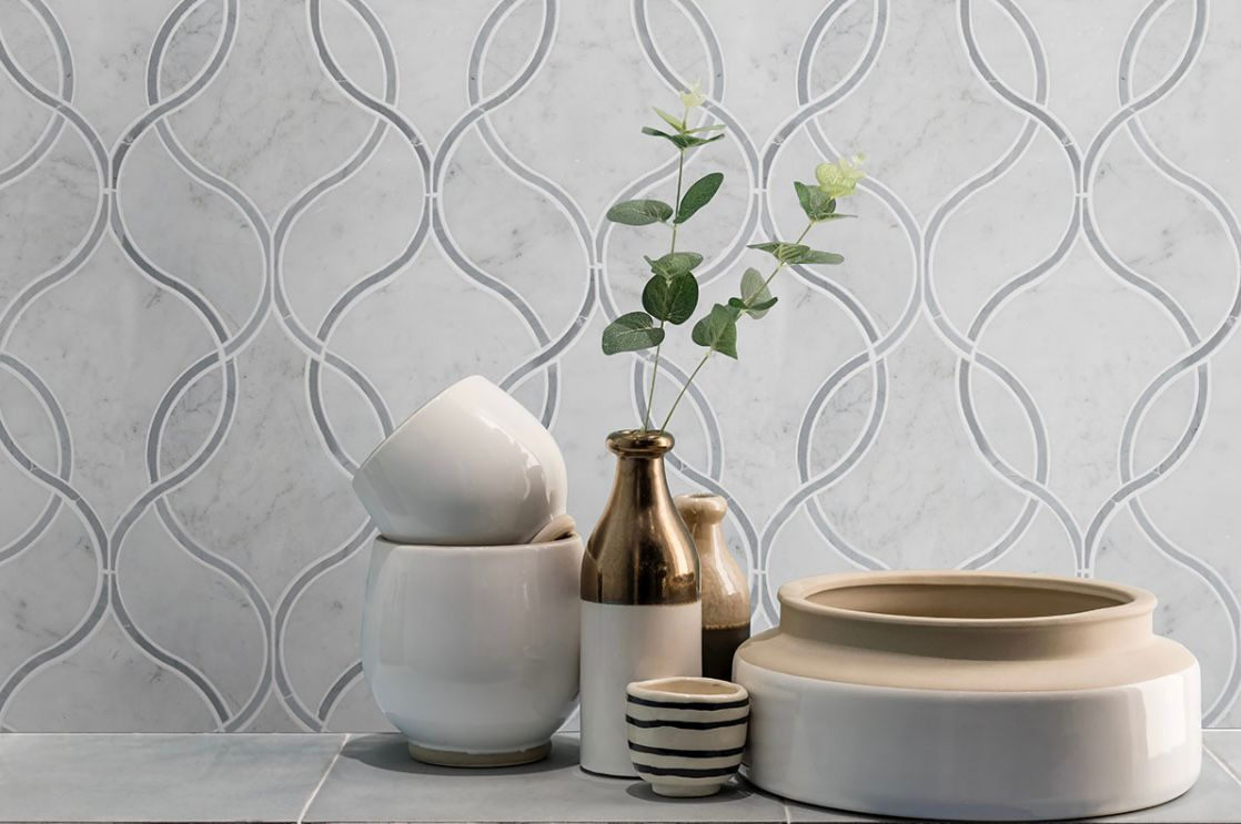 Carrara Marble collection showing soft grey veining on white background, ideal for bathroom, backsplash, and flooring applications