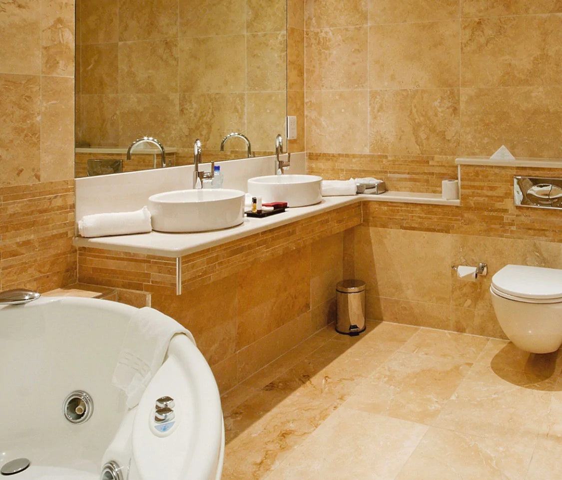 Close-up of Tuscany Gold Travertine tile with golden yellow and rust tones in natural finish