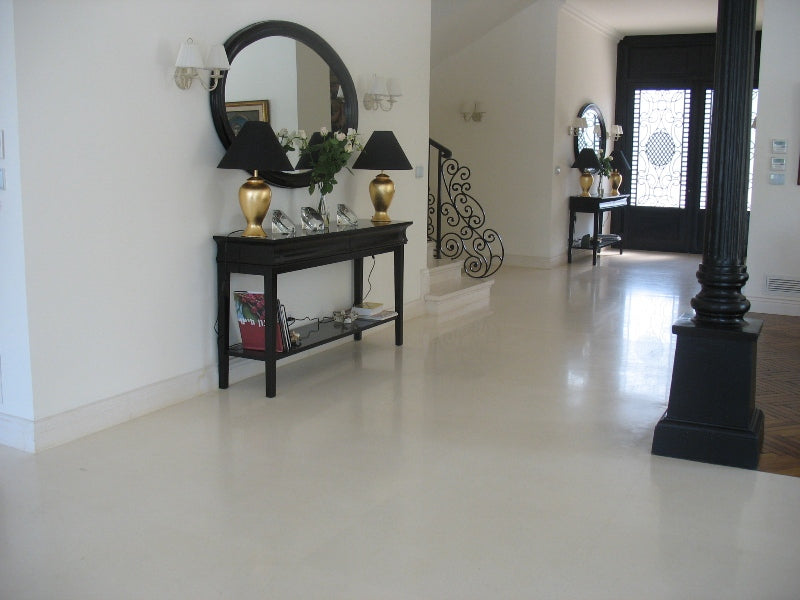 Installed view of white limestone tiles in a modern interior setting, showing natural veining and soft cream tones