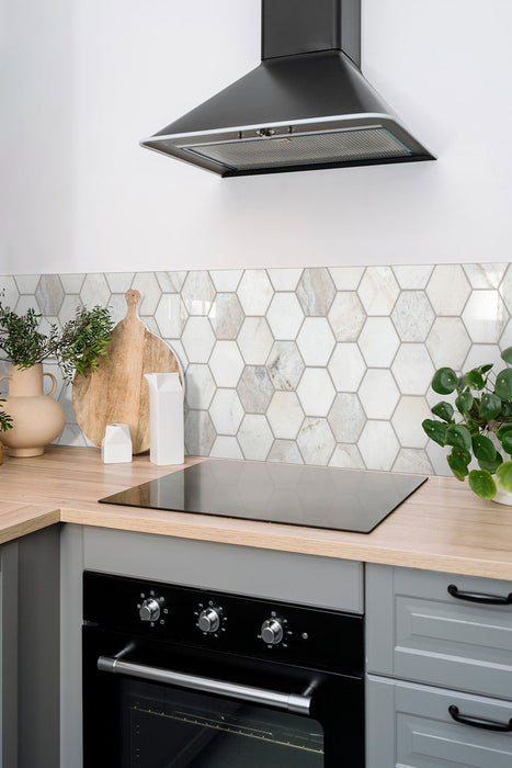 Arabescato Venato White hexagon tile installed as a backsplash in a modern kitchen.