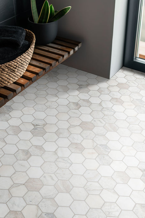 Arabescato Venato White hexagon tile installed as bathroom floor and wall feature