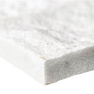 Close-up of Arctic White Quartzite showing split-face texture and dimensional surface