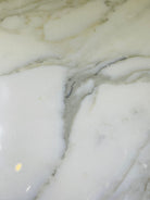 Close-up of Calacatta 12x24 tile showing elegant veining and polished surface