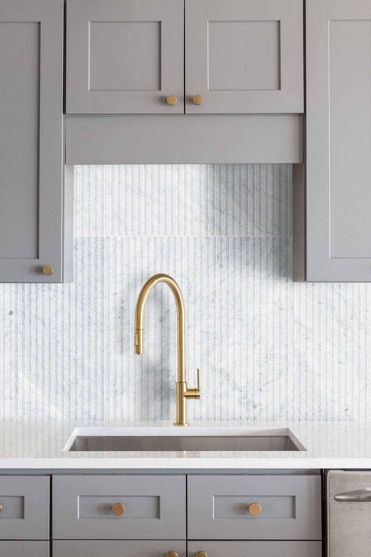 Carrara White Valentino Fluto Marble Tiles installed on kitchen wall with honed finish