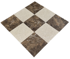 Close-up of Checkerboard Cream Nouva and Dark Emperador marble tiles with polished finish