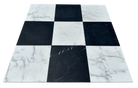 Close-up of Statuary and Nero Marquina checkerboard marble showing natural veining and polished contrast