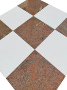 Close-up of checkerboard tile with bright Thassos marble and burgundy Bordeaux granite squares