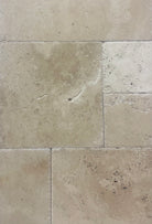 Versailles pattern Coliseum Travertine with brushed and chiseled finish in neutral gray and cream tones